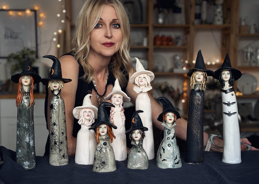 Handbuilt porcelain Tulip Queen sculptures displayed on a light wood sideboard
