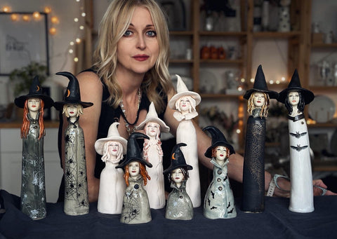 Handbuilt porcelain Tulip Queen sculptures displayed on a light wood sideboard