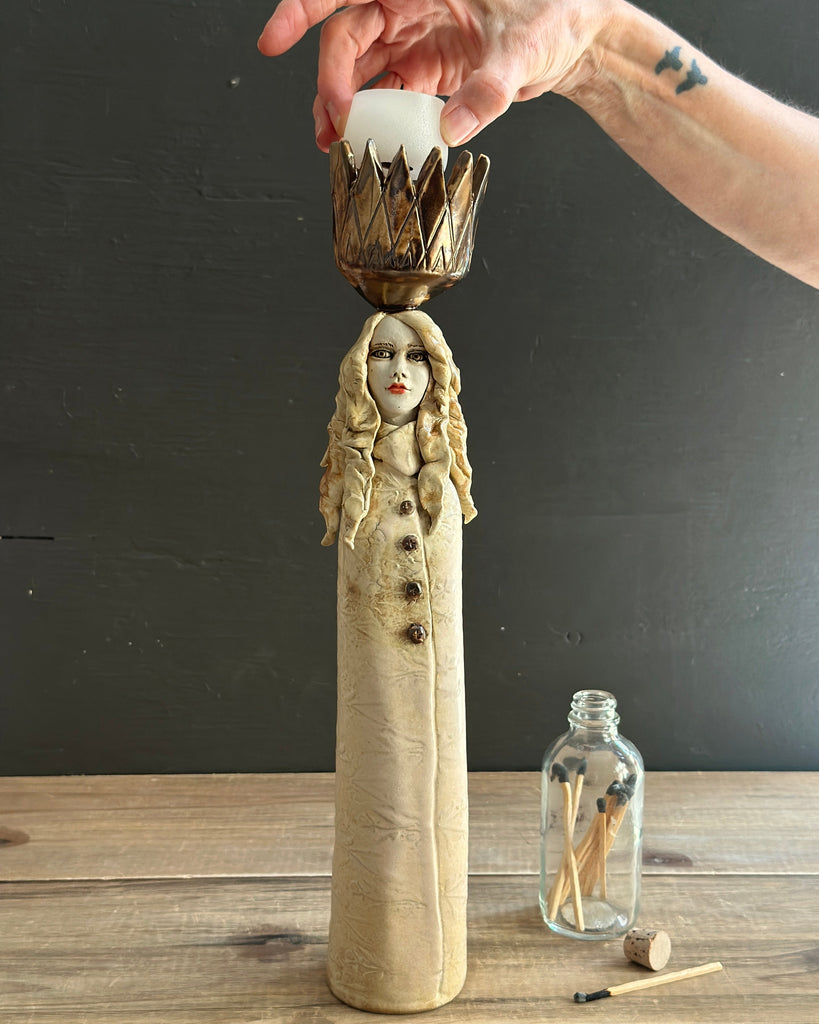 Handbuilt porcelain Tulip Queen sculptures displayed on a light wood sideboard