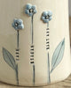 Decorative vase with white flowers on a wooden surface