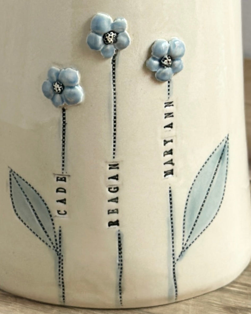 Decorative vase with white flowers on a wooden surface